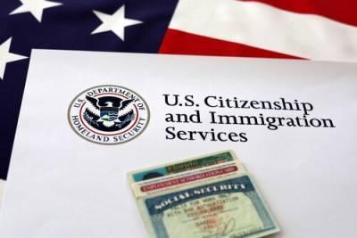 U.S. Citizenship and Immigration Services document with a green card against an American flag background