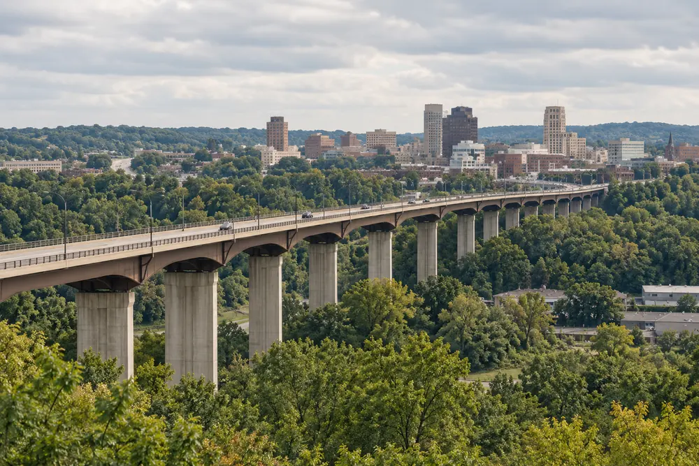 A high-level bridge crossing the wooded valley below downtown Akron